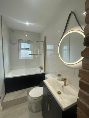 a bathroom with a toilet and a sink and a mirror at Cozy House in Crookes in Walkly