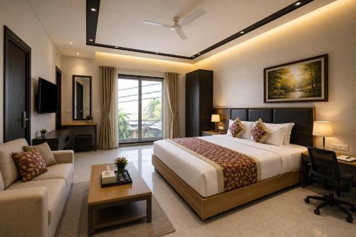 a hotel room with a large bed and a couch at Hotel West Residency Delhi Airport in New Delhi