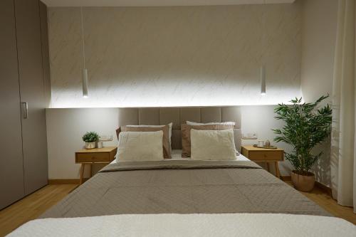 a bedroom with a large white bed with two tables at Elegant Villa In Vari With Private Pool in Vari