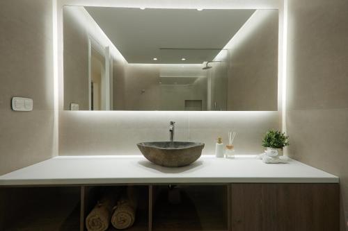a bathroom with a sink with a large mirror at Elegant Villa In Vari With Private Pool in Vari