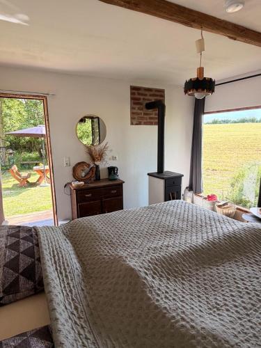 a bedroom with a bed and a wood stove at Schmöllner Eierlei in Schmölln