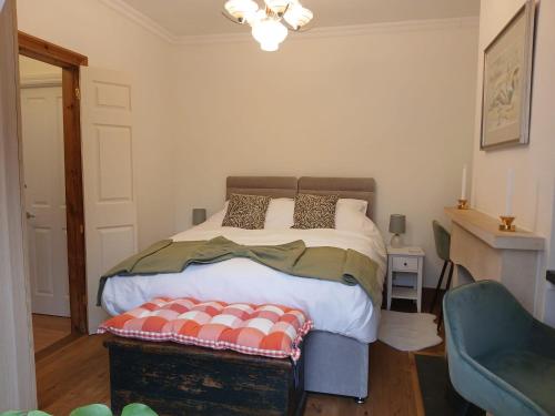 a bedroom with a large bed and a chair at Railmans Rest in Faversham
