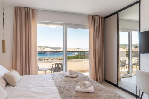 a bedroom with a bed with a view of the ocean at Villa Amarea in Lopar