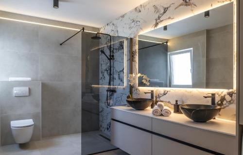 a bathroom with two sinks and a shower at Villa Amarea in Lopar