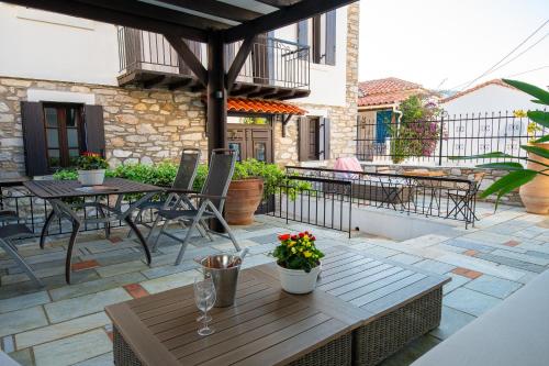 a patio with a table and chairs on a patio at The Dream House Skiathos in Skiathos