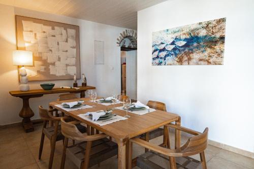 a dining room with a wooden table and chairs at The Dream House Skiathos in Skiathos