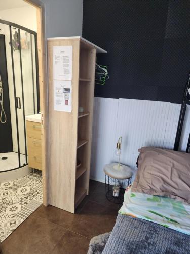 a bedroom with a bed and a closet and a desk at Studio chaleureux sans-visà-vis in Vernon