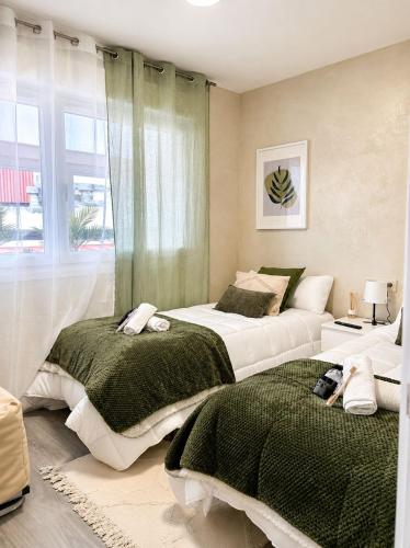 a bedroom with two beds and a window at Mirador da Guarda in A Guarda