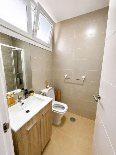 a bathroom with a toilet and a sink and a window at Mirador da Guarda in A Guarda