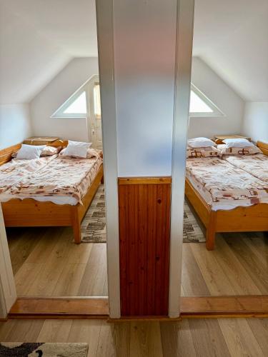 a room with two beds and a window at Casuta-Maria-Kisház in Sovata