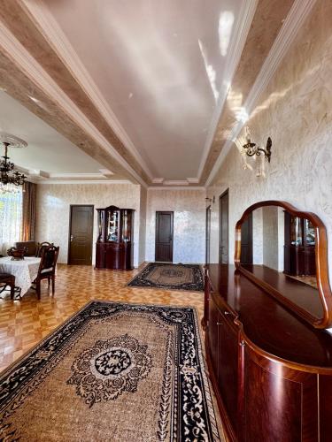 a large living room with a table and a couch at Guest House in Sarpi in Batumi