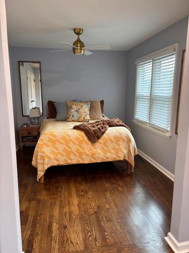 a bedroom with a bed and a mirror at Eclectic & Fun Custom Home in Shawnee