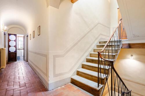 a staircase in a home with white walls at House on the river in Calci