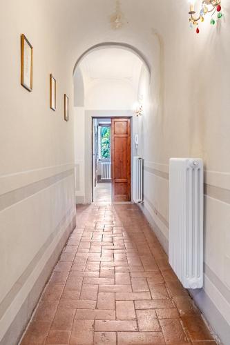 a hallway with a door and a tile floor at House on the river in Calci
