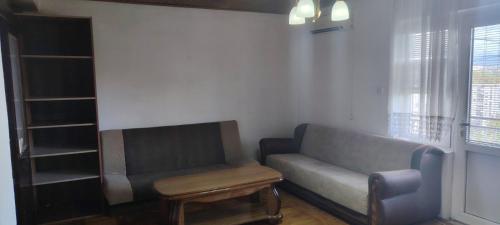 a living room with a couch and a stool at stan in Podgorica