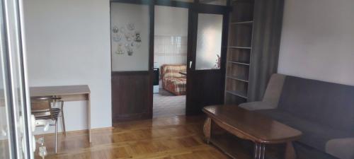 a living room with a couch and a table at stan in Podgorica