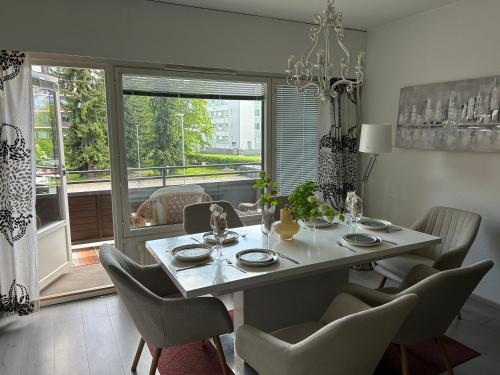 a dining room with a table and chairs and a window at Large apartment in the centre of Jyväskylä with private swimming pool and sauna in Jyväskylä