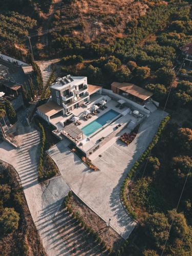 an aerial view of a house with a swimming pool at La Brise Luxury Suites in Nea Peramos