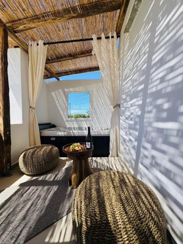 a room with two chairs and a table with a bottle of wine at Asterias Studios in Agia Anna Naxos