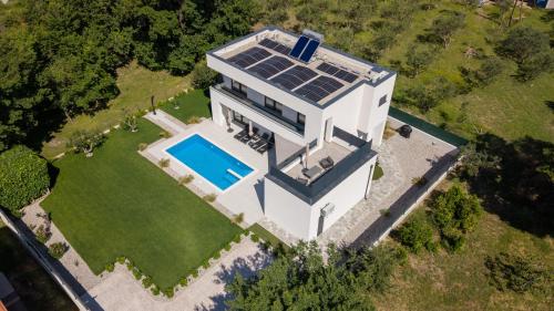 an aerial view of a house with solar panels on it at Villa Basini 5km from the centre of Split,Heated pool in Solin