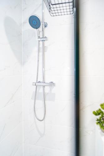 a shower with a shower head in a bathroom at Gabriel's Gaff in Maidstone