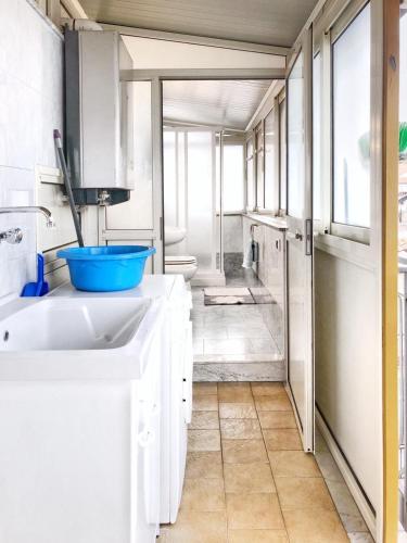 a white bathroom with a sink and a shower at Tiziana in Giardini Naxos