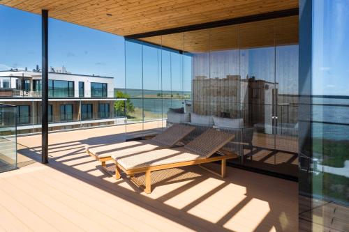 a balcony with a table and chairs on it at MarienHome Loojangu in Haapsalu