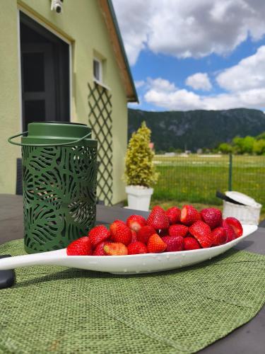 a plate of strawberries sitting on a table at Home Delic Komarnica in Šavnik