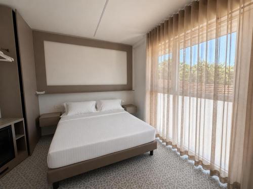a bedroom with a bed and a large window at GG Landlords Room & Spa in Vasto