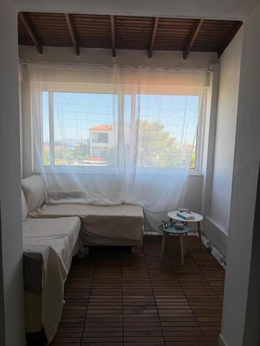 a room with two beds in front of a window at Naja's Studio in Souvala