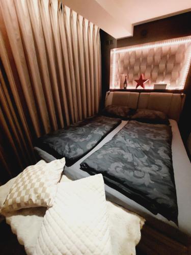 a bedroom with two beds and a star on the wall at La Suite in La Calamine