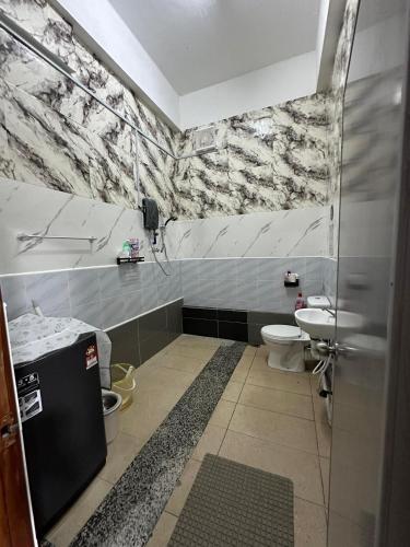 a bathroom with a sink and a toilet at RY Homestay in Tawau