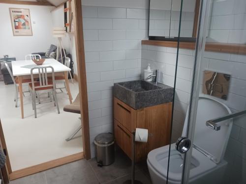 a bathroom with a sink and a toilet and a table at Oak framed appartment in Chester