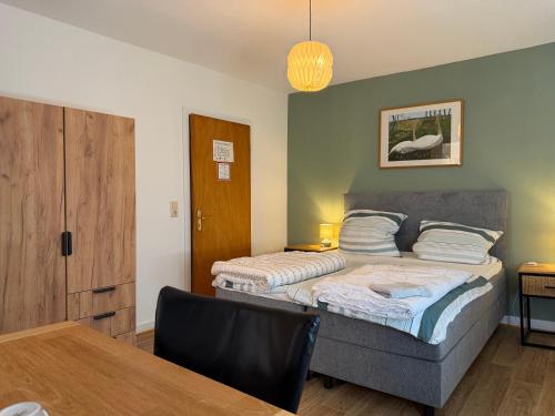a bedroom with a bed and a dining room table at Haus Waldesruh in Nettetal