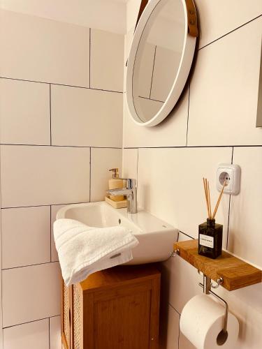 a bathroom with a sink and a mirror at Cozy Apartment in Bad Oldesloe