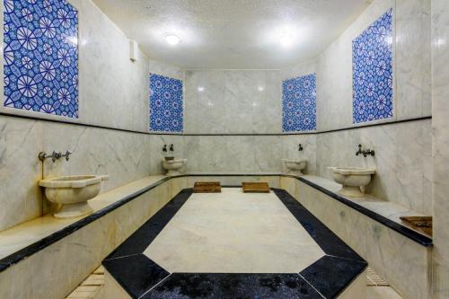 a bathroom with two toilets and blue windows at Apollonium Bozbuk in Akbük