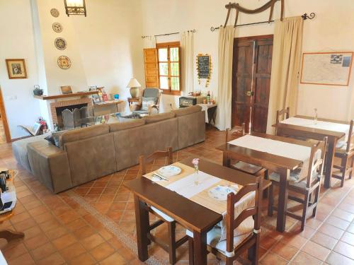 a large living room with a couch and tables at Escuela La Crujía in Vélez-Málaga