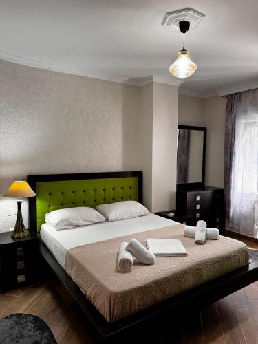 a bedroom with a large bed with towels on it at Apartment in Durres Elio in Golem
