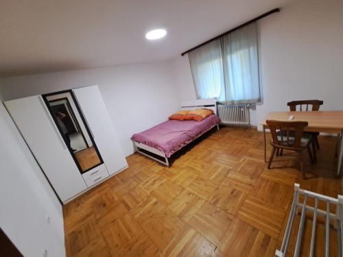 a bedroom with a bed and a table and a mirror at MHm in Passau