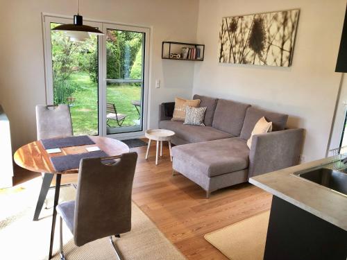a living room with a couch and a table at Haus zum See in Uhldingen-Mühlhofen