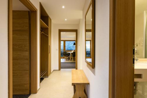 a hallway leading to a dining room with a table at Sporthotel Walliser in Hirschegg
