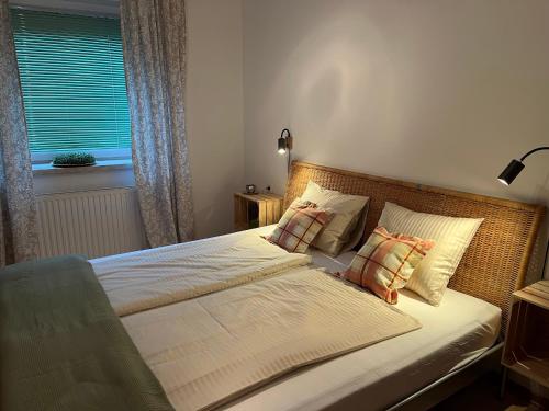 a bedroom with a bed with two pillows and a window at Panoramic Alpine Residence in Eisenerz