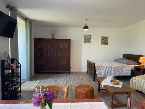 a living room with a bedroom and a bed at Gite de la vallée in Rochechouart