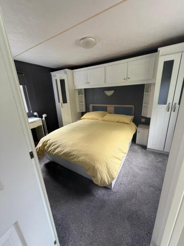 a bedroom with a bed with a yellow bedspread at Lisa retreat in Preston