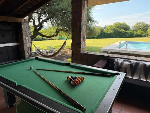 a pool table with balls on top of it at Quinta lo de Dito in Villa Allende