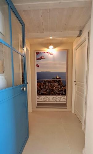a door to a room with a view of a balcony at Addor 'e Mare in Bacoli