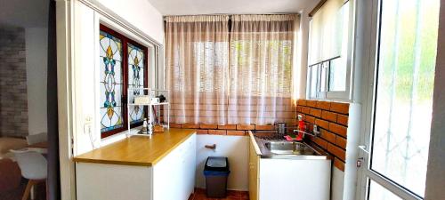 a small kitchen with a sink and a window at Nice house close to the sea in Mati