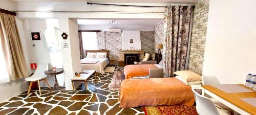 a room with two beds and a living room at Nice house close to the sea in Mati