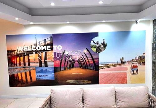 a living room with a large poster on the wall at DURBAN BEACHFRONT Tenbury 903 in Durban