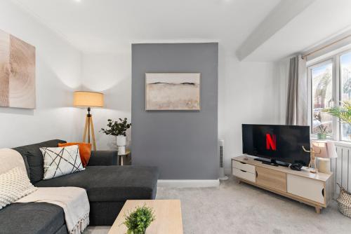 a living room with a couch and a tv at Spacious Modern 2BR - Parking - Workspace Area, Ideal for Contractors & Long Stays - NordStay in Amley